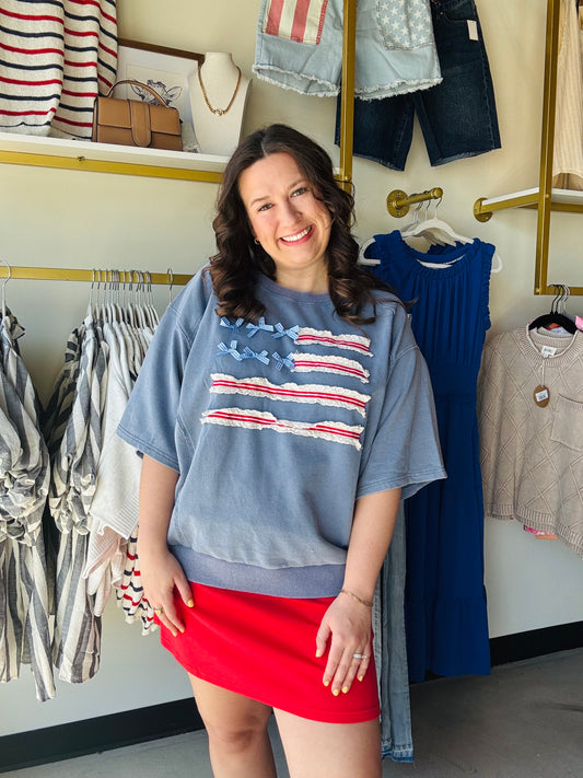 Easel

Combine chic Americana with ultimate comfort. This mineral-washed terry pullover features a unique lace-trimmed American flag and a relaxed, oversized fit perfect for patriotic celebrations or effortless everyday style.

Ultra-relaxed, oversized silhouette.
Soft, breathable cotton-rich knit.
Vintage-inspired mineral wash finish.
Intricate lace and ribbon detailing.
Flattering dropped shoulders, half sleeves.
Festive, patriotic Americana design.