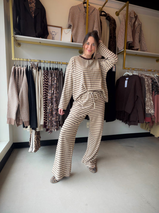 Meet your excuse to linger over that second cup of coffee. The Jersey Stripe Brushed Lounge Set by Anniewear pairs a relaxed long-sleeve pullover with matching wide-leg pants for an effortlessly coordinated look. Soft, brushed stretch jersey brings the cozy feel, while thin stripes and contrast neck trim add a little polish to your downtime.

Whether you're easing into a quiet morning, settling in for movie night, or slipping on sneakers for a casual outing, this two-piece set makes getting dressed beautifu