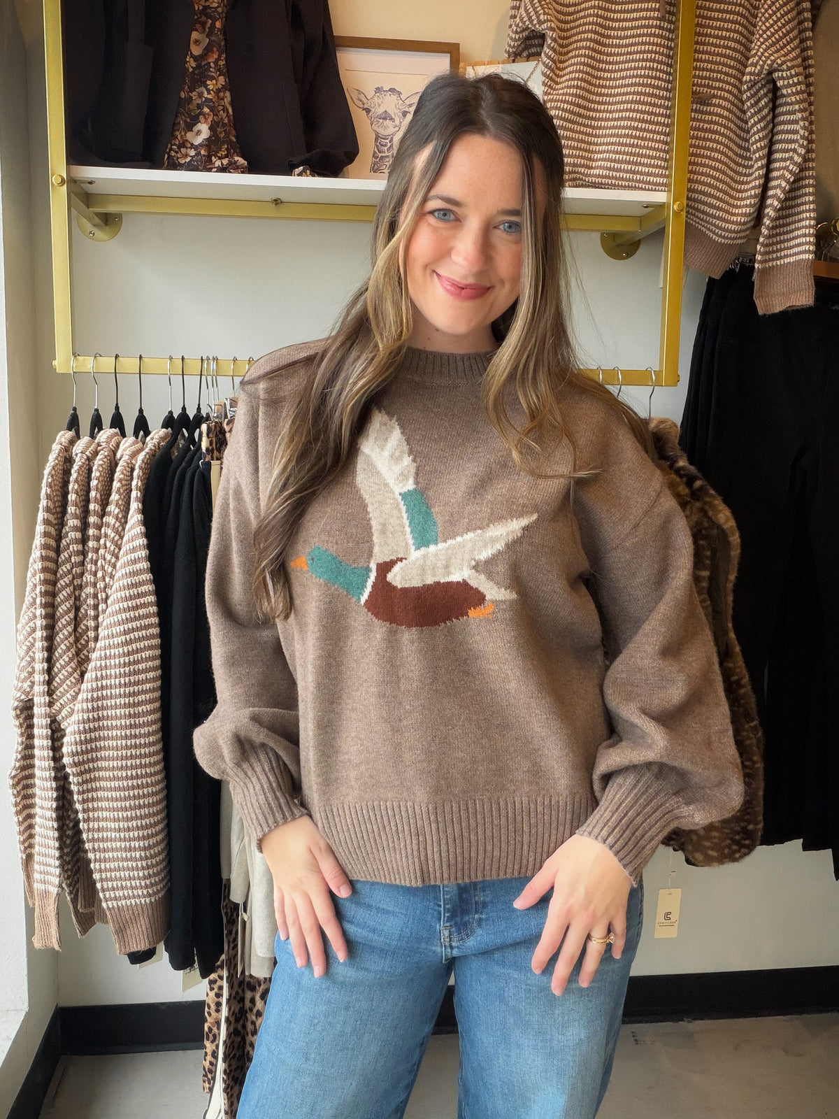 A Little Outdoorsy Charm, a Lot to Love

Meet the sweater that brings a playful twist to your cozy-day lineup. Our Mallard Balloon Sleeve Sweater by Anniewear features a flying mallard knit design across the front, giving this easy pullover a personality all its own. The soft knit and relaxed, loose silhouette make it an inviting pick for slow mornings, coffee dates, and crisp afternoons spent browsing your favorite shops.

A classic round neckline keeps the look simple, while dropped shoulders and long bal