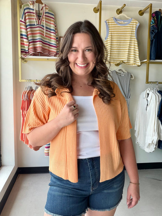 Sweet, warm, and endlessly wearable. The Apricot Short Sleeve Cardigan by Sunday Edition is a lightweight sweater cardigan in a soft apricot hue that pairs with practically everything in your closet. The button-front closure and half-sleeve cut give it a polished, put-together look that works from the office to a weekend outing.

Layer it over a tank or slip dress for an effortless warm-weather outfit, or toss it on as a light cover-up on breezy evenings.

Button-front closure
Short (half) sleeve
Lightweigh