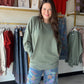Soft, slouchy, and seriously cozy. The&nbsp;Army Green Pigment Dyed Pullover by Zenana is your new favorite weekend essential. Made from 100% cotton French terry, it has that perfectly worn-in feel with a pigment dye finish that gives it a subtle, vintage-inspired depth of color unique to each piece.

Ribbed detailing adds a polished touch, and the handy pockets make it as practical as it is stylish. Whether you're running errands or lounging at home, this relaxed pullover does it all in effortless dusty bl
