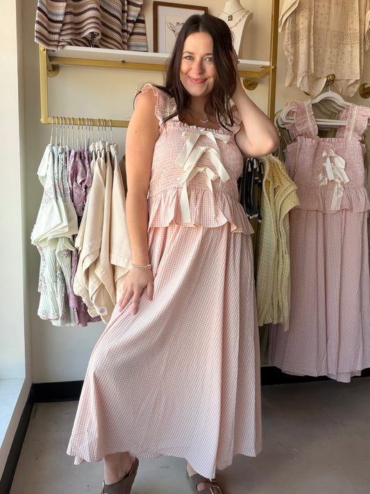 Blush Gingham Smocked Midi Dress

Romantic, feminine, and made for the moments worth dressing up for. This dreamy midi dress features a smocked bodice, delicate lace tape trim, and ruffled bow details that make it feel effortlessly special. The classic gingham print in blush tones keeps it fresh and versatile — perfect for brunch, a garden party, or a summer date night.

Smocked bodice for a flattering, stretchy fit
Lace tape trim with ruffled bow details
Classic gingham print in blush
Midi length
Fully lin