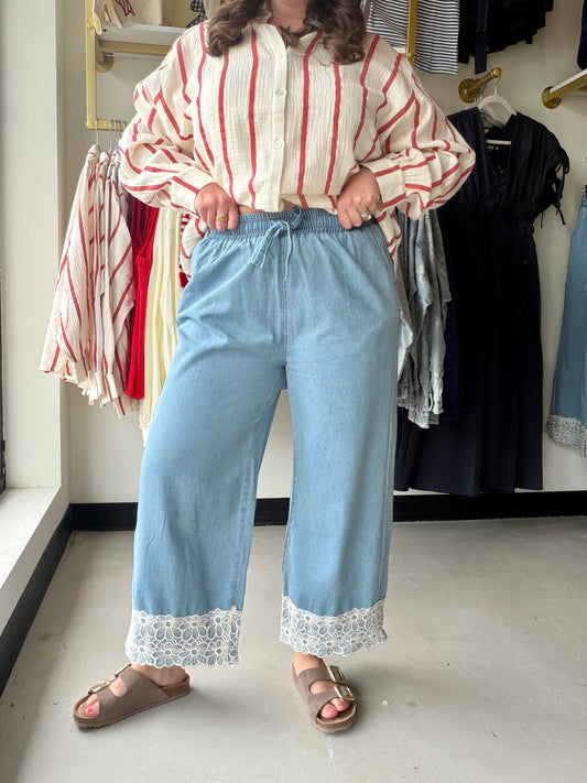 Bibi

Experience ultimate comfort in these Bibi 100% cotton washed denim pants, elevated by an intricate floral lace hem. The adjustable drawstring waist and breezy wide-leg cut deliver an effortless boho-chic look for any season.

Ultra-soft 100% breathable cotton denim.
Intricate, feminine floral lace hem.
Comfortable adjustable drawstring elastic waist.
Functional pockets for your essentials.
Flattering, relaxed wide-leg silhouette.
Versatile boho-chic everyday style.
