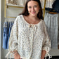 Bibi

Some pieces just feel like summer. The Vintage Floral Gauze Blouse is one of them — a breezy 100% cotton gauze top with a romantic vintage floral print that looks like it was pulled straight from a sun-soaked afternoon.

An adjustable neckline lets you wear it open and relaxed or cinched for a more defined look, while the adjustable sleeve hem gives you the flexibility to go full-length or roll them up when the heat hits. The lightweight gauze fabric is airy and soft against the skin, making this one 