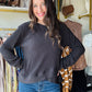 Umgee

This black long sleeve pullover features an expert design with an asymmetrical layered hemline that adds a modern edge to your wardrobe. The classic crewneck offers a clean, versatile look, while the unlined construction ensures lightweight comfort and easy layering. Perfect for those seeking a sophisticated yet contemporary top.