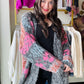 Wrap yourself in the cozy comfort and whimsical charm of our Black Mauve Motif Fuzzy Cardigan. The oversized floral knit adds a playful touch while the open-front silhouette and ribbed hemlines provide a relaxed fit. With drop shoulder long sleeves and a fuzzy textured knit, this cardigan is the perfect addition to your wardrobe.