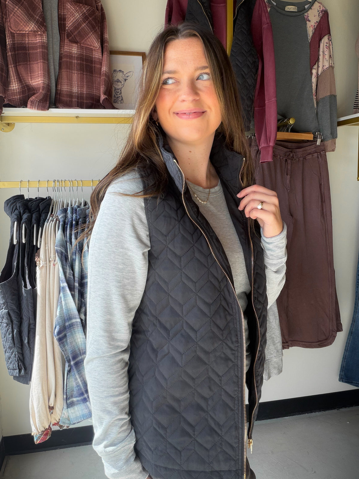 The layer that makes a simple outfit feel finished. The Black Quilted Zip Up Vest by Umgee brings quilted texture to a classic black, sleeveless silhouette. Zip it over a long-sleeve tee for a morning out, or layer it over a sweater when you want to add dimension without hiding the outfit underneath.

Details to love

Quilted design adds texture to everyday looks.
Zip-up front for easy layering.
Versatile black color.
Fabric: 100% polyester.
Fit &amp; styling

Sophie is wearing the Small. Size guide: Small 