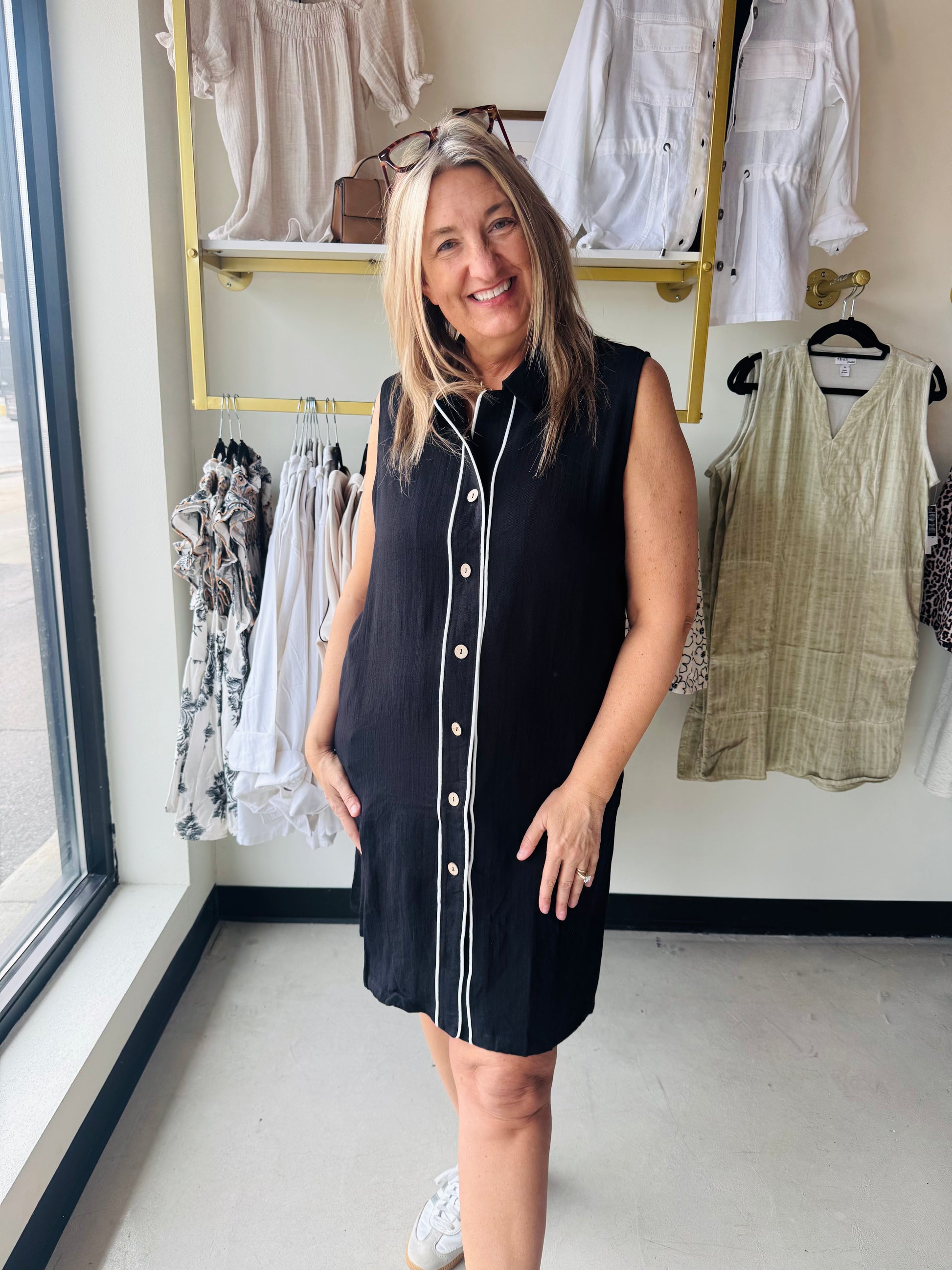 Black collared sleeveless button up dress with white piping