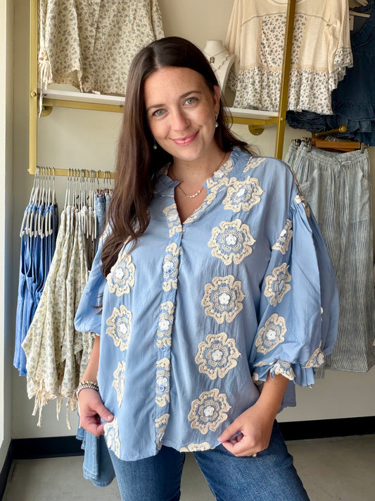 Bibi

Make a statement without saying a word. The Blue 3D Floral Bubble Top is a showstopper — dimensional floral appliqués give it a sculptural, fashion-forward look that's anything but ordinary, while the rich blue hue makes it impossible to overlook.

Crafted from a soft Tencel blend with a fully lined body, it drapes beautifully and feels luxurious against the skin. The bubble silhouette adds volume and movement in all the right places, making this one of those pieces that photographs just as well as it