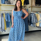 Staccato

Radiate summer elegance in this stunning blue floral maxi, featuring a flattering smocked bodice and breezy double-scoop neckline. Fully lined and effortlessly sleeveless, it’s the ultimate choice for sun-drenched brunch dates or coastal getaways.

Flattering smocked bodice hugs your curves.
Breezy sleeveless cut for hot days.
Elegant double-scoop neck adds sophistication.
Fully lined for confident, worry-free wear.
Flowy maxi length offers effortless movement.
Vibrant floral print for timeless st