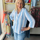 Dash&nbsp;

A breezy essential for warm-weather days, this lightweight gauze button-up features a classic vertical stripe pattern in calming blue tones. The three-quarter sleeves offer the perfect balance of coverage and breathability, while the soft gauze fabric drapes beautifully against the skin. Effortlessly versatile—wear it solo on lazy afternoons or layer it over a tank for added dimension. Perfect for casual outings, beach trips, or relaxed weekend wear.