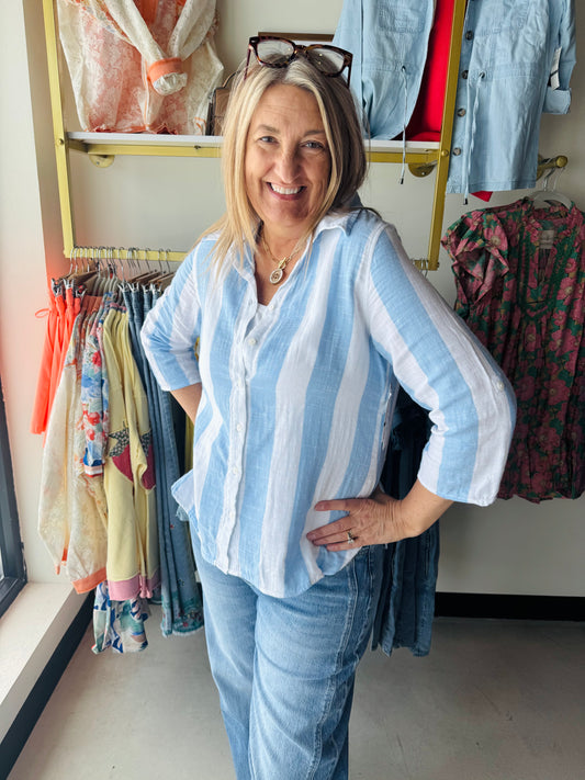 Dash&nbsp;

A breezy essential for warm-weather days, this lightweight gauze button-up features a classic vertical stripe pattern in calming blue tones. The three-quarter sleeves offer the perfect balance of coverage and breathability, while the soft gauze fabric drapes beautifully against the skin. Effortlessly versatile—wear it solo on lazy afternoons or layer it over a tank for added dimension. Perfect for casual outings, beach trips, or relaxed weekend wear.