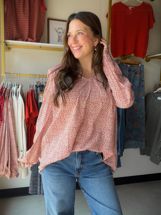 The perfect blend of feminine detail and easy elegance. The Brick &amp; Ivory Smocked Blouse features a flattering smocked V-neckline and long sleeves that make it a versatile piece you can wear season after season. The rich brick and ivory colorblock gives it a fresh, editorial feel that pairs beautifully with denim, trousers, or a midi skirt.

Smocked V-neckline
Long sleeve silhouette
Brick &amp; ivory colorblock detail
100% Polyester — lightweight and easy care
Total length 27" | Bust 22" | Sleeve length