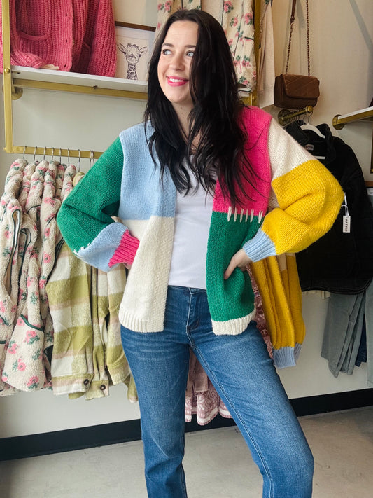 Bibi&nbsp;

Elevate your winter wardrobe with our Pink Multi Block Cardigan. This open front cardigan features a mix of pink, ivory, yellow, green, and blue, accented with stitch detailing for added style. Stay cozy and stylish with a pop of color.