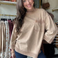 Easel

This Mocha Knit Pocket Crewneck features 3/4 length sleeves and a classic crew neckline for a refined, comfortable fit. The subtle braid detailing adds texture and visual interest, making it a sophisticated choice for fall layering. Perfect for transitioning seasons, this sweatshirt combines effortless style with cozy warmth.