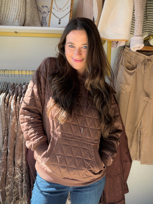 The Brown Quilted Accent Hoodie by Staccato brings a thoughtful detail to an everyday favorite. Its rich brown color and quilted accent give your casual wardrobe a fresh touch, making it an easy choice for coffee runs, weekend browsing, and laid-back afternoons.

Picture it paired with your favorite jeans and sneakers for a day out, then styled with leggings when the evening calls for a more casual look. The brown shade works beautifully with cream, denim, and other earthy tones, while the quilted accent ad