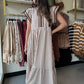 This brown cap sleeve dress features a textured striped pattern enhanced by tiered ruffle flutter sleeves with contrast accent binding detail for a refined look. Crafted from lightweight woven fabric, it offers a comfortable, non-sheer feel and includes convenient side pockets. Fully lined for added comfort and modesty, this dress combines style and functionality with expert design elements.

Entro