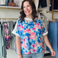 Elevate your everyday style with this vibrant watercolor floral blouse featuring chic contrast detailing and a breezy, woven fit. Flattering side slits and an artistic print make it the ultimate choice for effortless summer elegance and all-day comfort.