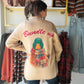 A Cozy Layer with a Playful Surprise

Classic from the front, full of personality from the back. The Bundle Up Sweater Cardigan by Anniewear brings a charming twist to your cool-weather wardrobe with a scarf-wearing duck and cheerful red “Bundle up” lettering across the back. Its warm beige color keeps the look easy to pair, while the colorful plaid scarf adds just the right touch of seasonal fun.

Slip it on for a coffee run, a weekend gathering, or an afternoon exploring your favorite little shops. The op