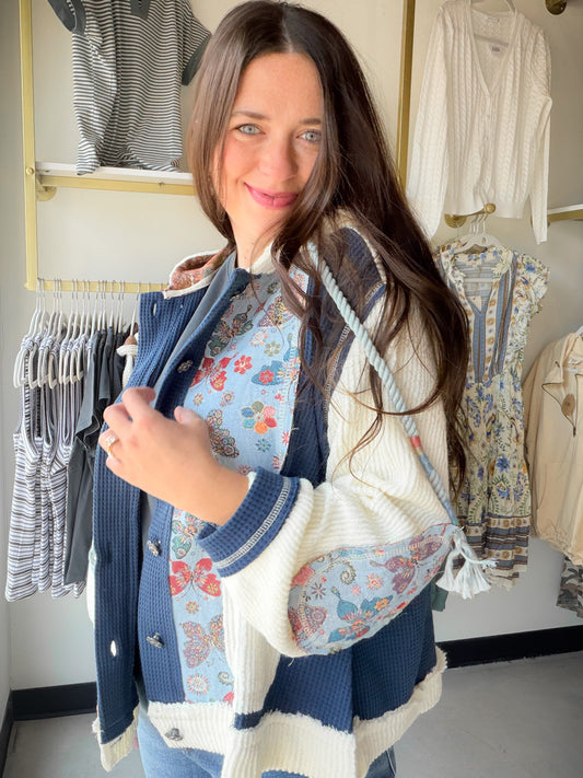 Feminine meets laid-back in the Indigo Butterfly Placket Hoodie by POL. This relaxed-fit top is crafted in a soft thermal fabric with a delicate pointed floral pattern, giving it a boho-chic charm that's anything but ordinary. Balloon sleeves add a touch of romantic volume, while the placket hoodie detail keeps things effortlessly casual.

Overlock stitch detailing lends a slightly raw, artisan edge — the kind of thoughtful detail that makes this piece feel special. Wear it as a cozy layer or let it stand o