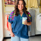 The details are everything on this one. The Chambray Vibrant Sleeve Dolman Top by Umgee is a charming embroidered denim blouse with short puff sleeves, elastic cuffs, and a split V-neckline trimmed with delicate embroidery. The contrast stitching adds an artisan touch that makes this top feel truly special.

Lightweight and breathable in a cotton-blend chambray, it pairs beautifully with white denim, linen trousers, or a flowy midi skirt for an effortlessly put-together warm-weather look.

Split V-neck with