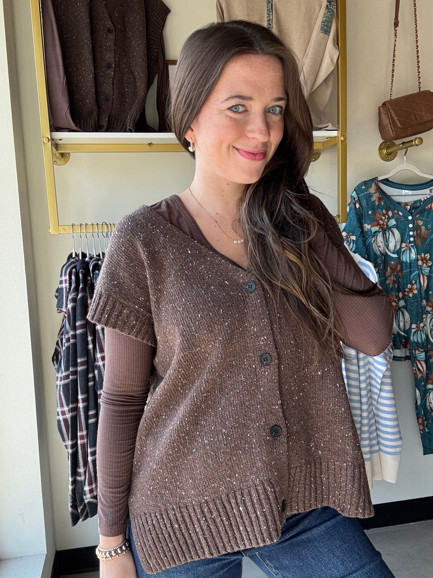 Mustard Seed&nbsp;

Get cozy and cute with this Dark Chocolate Sweater Vest! Featuring functioning buttons and playful cap sleeves, it’s perfect for layering any outfit. The ribbed detailing adds a fun texture twist while keeping things comfy and stylish. Perfect for when you want a little warmth with a lot of charm.