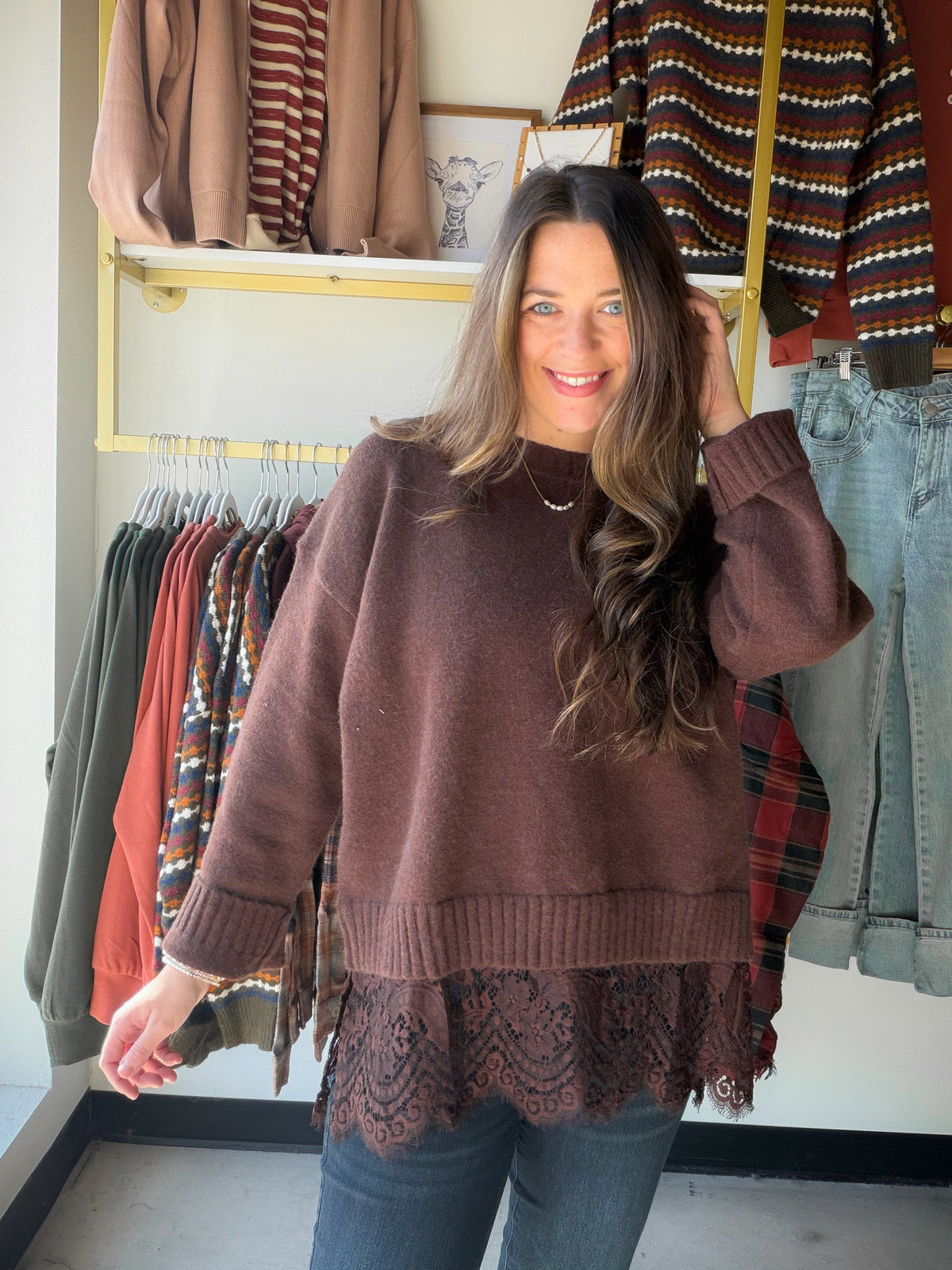 A Little Romance for Your Everyday Wardrobe

Rich chocolate brown meets delicate lace in this Anniewear sweater, giving an everyday knit a beautifully feminine finish. The simple sweater silhouette lets the details shine: ribbed edges, roomy-looking sleeves, and a wide band of floral lace extending below the hem.

It is an easy choice for those days when you want something more dressed up than a basic sweater without putting together a complicated outfit. Think lunch with friends, dinner plans, or a fall af