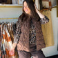 Layer up in style. The Brown Chunky Textured Vest by Creation is a wardrobe essential that brings cozy, elevated texture to any outfit — no sleeves needed.

The rich chunky knit-inspired texture and warm brown tone make this vest incredibly versatile — throw it over a turtleneck, a long-sleeve tee, or a button-down for an effortlessly put-together look. A perfect transitional piece from season to season.

Chunky textured fabrication
Sleeveless silhouette
100% Polyester
Available in sizes S–XXL
Sophie is wea