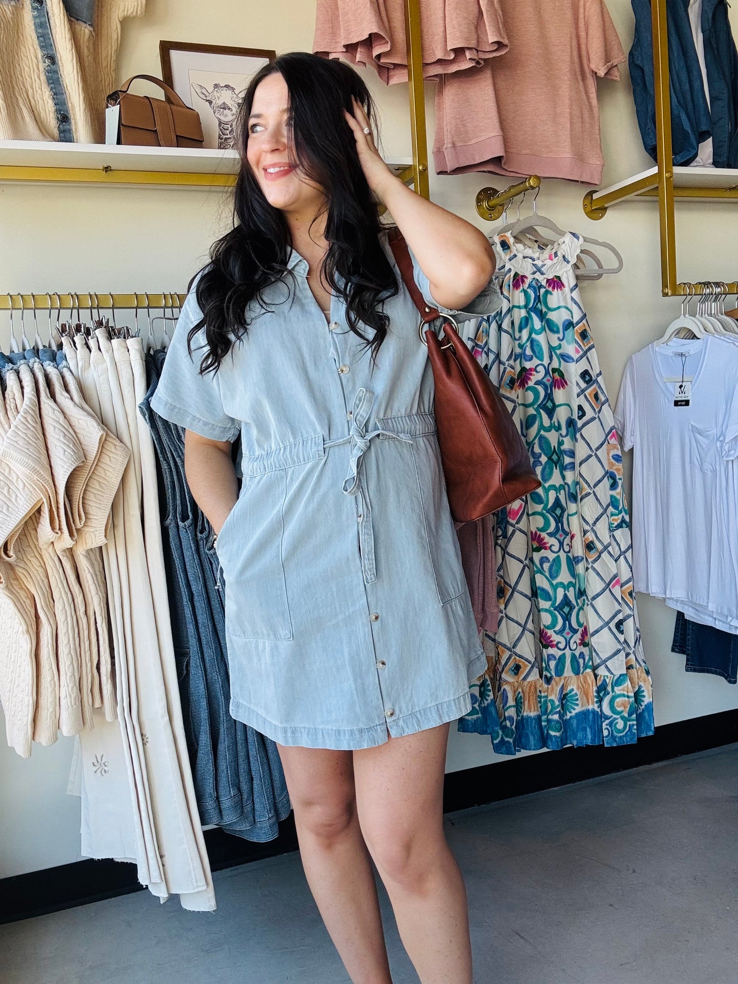 Wishlist&nbsp;

Elevate your casual wardrobe with this classic collared denim mini dress. Featuring functional buttons down the front, a flattering self-tie waist for a customizable fit, and practical side pockets for everyday convenience. The timeless denim construction pairs effortlessly with sneakers or heels, making it a versatile staple for any season. Perfect for weekend outings, casual dates, or laid-back office vibes.