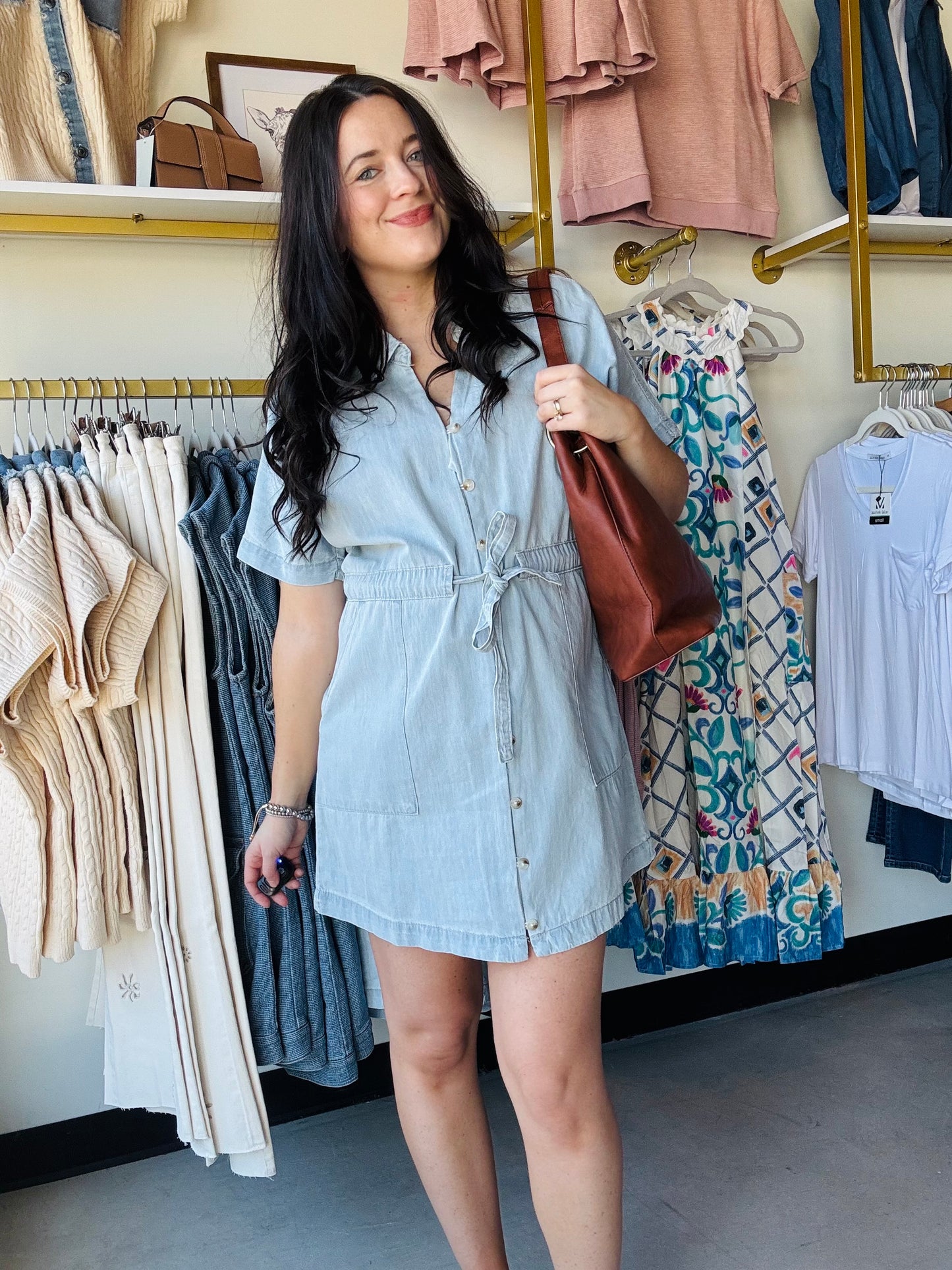 Wishlist&nbsp;

Elevate your casual wardrobe with this classic collared denim mini dress. Featuring functional buttons down the front, a flattering self-tie waist for a customizable fit, and practical side pockets for everyday convenience. The timeless denim construction pairs effortlessly with sneakers or heels, making it a versatile staple for any season. Perfect for weekend outings, casual dates, or laid-back office vibes.