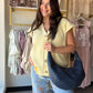 The it-piece your wardrobe has been waiting for. The Lemon Distressed Sweater Vest by Cotierra brings effortless cool-girl energy with its bold oversized silhouette and lived-in distressed detailing. A button-front, V-neckline, and sleeveless design make it endlessly versatile — layer it over a fitted tee and denim for a casual daytime look, or wear it as a statement piece on its own.

Details:

Distressed knit texture for a relaxed, vintage-inspired feel
Button-front closure
V-neckline
Sleeveless vest silh