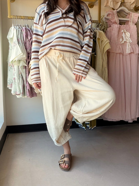 Breezy, relaxed, and effortlessly chic — the Natural Capri Lantern Pants by Cotierra are your warm-weather wardrobe staple. The lantern silhouette features a wide leg through the calf that tapers to a gathered ankle, creating a flattering, fashion-forward shape. A crinkle-textured fabric adds laid-back bohemian character, while the elastic drawstring waist keeps things comfortable and adjustable all day long.

Details:

Lantern-style silhouette — wide through the calf, tapered at the ankle
Capri length for 