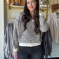 Tribal

Cozy up in this Cream Textured Knit Sweater featuring a chic V-neckline and playful drop shoulders for an effortlessly stylish look. The long sleeves and ribbed details at the cuffs, hem, and neckline add a snug touch, while the two-tone textured knit brings fun depth and warmth to your outfit. Perfect for layering or wearing solo on breezy days!