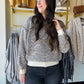 Tribal

Cozy up in this Cream Textured Knit Sweater featuring a chic V-neckline and playful drop shoulders for an effortlessly stylish look. The long sleeves and ribbed details at the cuffs, hem, and neckline add a snug touch, while the two-tone textured knit brings fun depth and warmth to your outfit. Perfect for layering or wearing solo on breezy days!