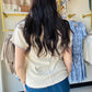 Designed in a V-neck short sleeve regular fit top crafted from soft cotton jersey. Featuring delicate contrast trim along the neckline and sleeve edges, this piece adds a subtle feminine touch to a classic silhouette. Finished with vintage washing for a naturally soft, lived-in feel, the lightweight fabric offers everyday comfort with effortless styling versatility. A timeless solid essential perfect for layering or wearing on its own.