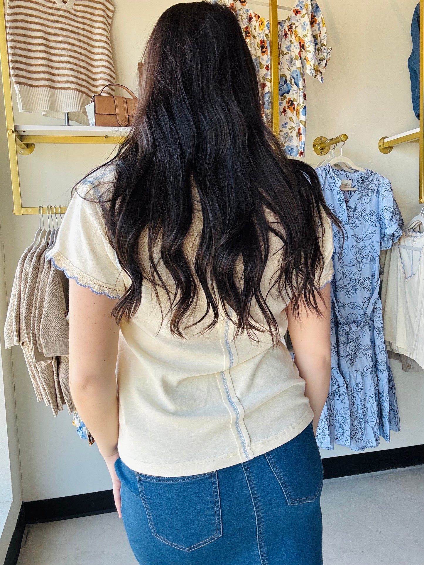 Designed in a V-neck short sleeve regular fit top crafted from soft cotton jersey. Featuring delicate contrast trim along the neckline and sleeve edges, this piece adds a subtle feminine touch to a classic silhouette. Finished with vintage washing for a naturally soft, lived-in feel, the lightweight fabric offers everyday comfort with effortless styling versatility. A timeless solid essential perfect for layering or wearing on its own.