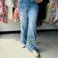 Make a statement in these Oli &amp; Hali wide-leg jeans, featuring intricate botanical embroidery and slimming front-dart detailing. These premium denim pants blend vintage boho charm with a modern, tailored silhouette for an effortlessly elevated look. Experience the perfect fusion of artistic flair and everyday comfort.

• Intricate, high-quality floral embroidery detail.
• Slimming front darts for tailored fit.
• Trendy wide-leg silhouette for comfort.
• Premium Oli &amp; Hali boutique denim.
• Artistic 