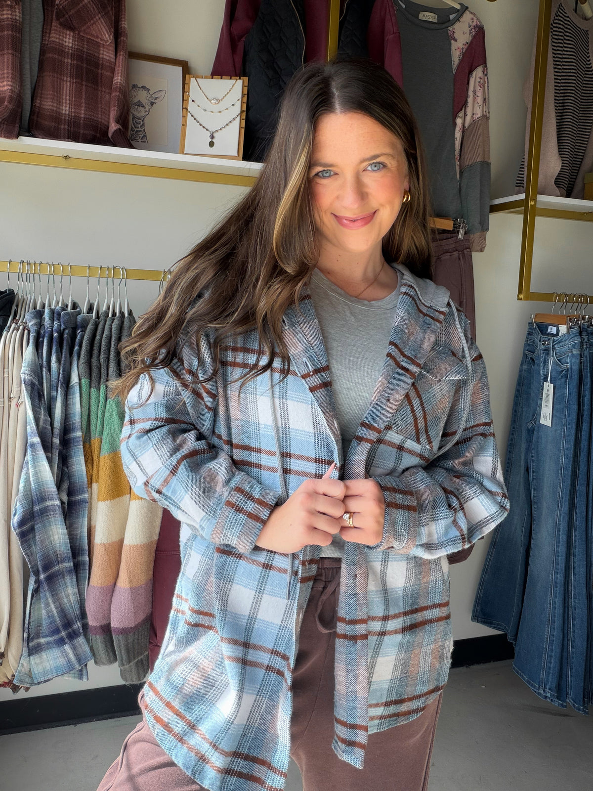 Meet the easy layer that pulls a casual outfit together. The Sky Blue &amp; Brown Plaid Hooded Shacket by Dash combines a soft-looking blue-and-brown plaid with a hooded, shirt-jacket silhouette. Throw it over a tee with jeans for a laid-back day, or bring it along when you want an extra layer.

Details to love

Sky blue and brown plaid pattern.
Hooded shacket styling for casual layering.
Fabric content: 75% cotton, 25% other fibers, as listed by the product.
By Dash.
Fit &amp; styling

Sophie is wearing th