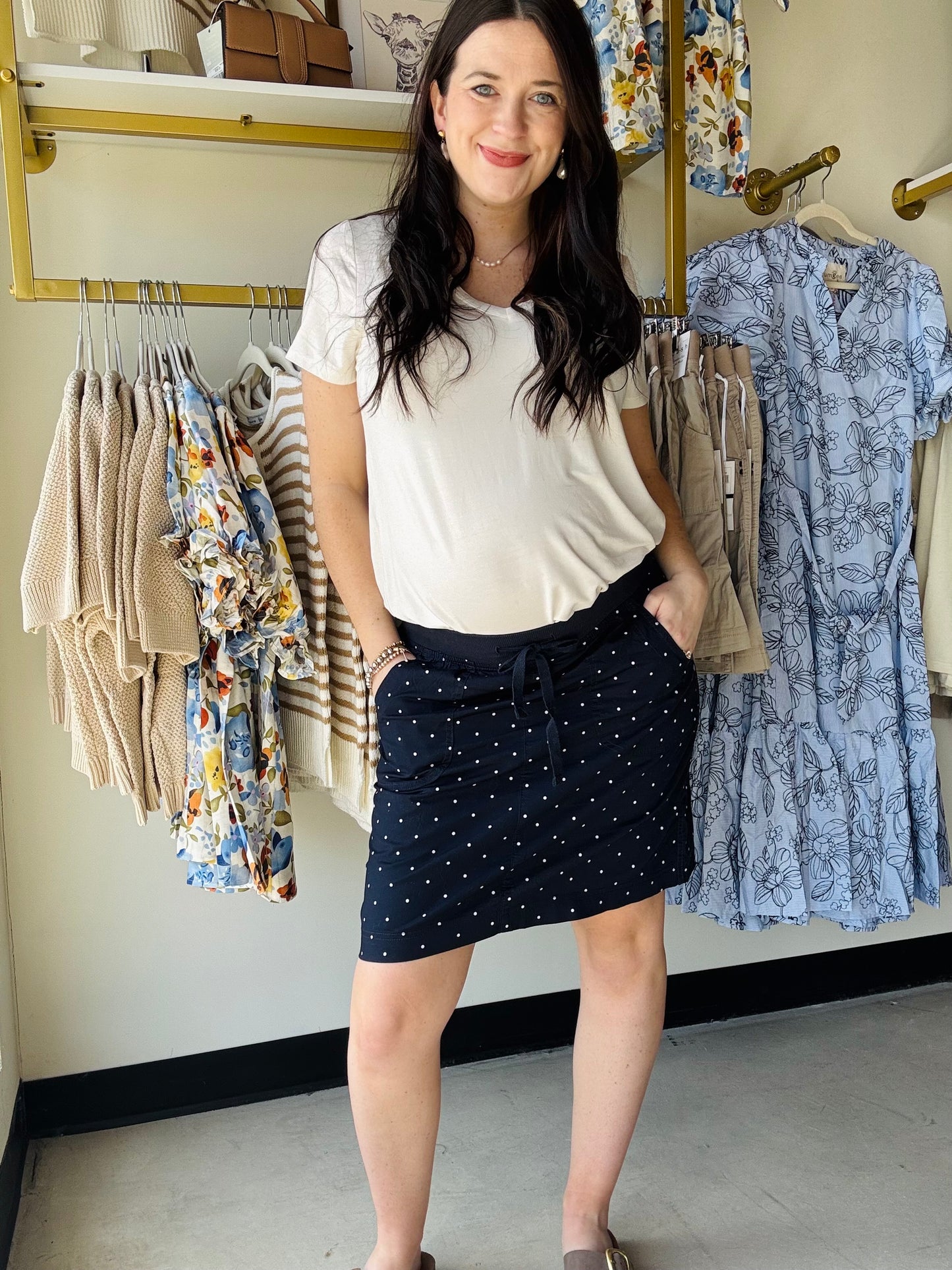 The Sharon Navy Dots Skort combines style and practicality with built-in shorts for worry-free movement. This casual, comfortable piece features a charming navy dot pattern that pairs effortlessly with white for endless summer outfit combinations. Perfect for warm-weather days when you want to look put-together without sacrificing comfort or modesty.