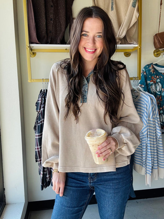 Embrace cozy vibes with the Khaki Denim Accent Pullover, featuring a mineral-washed finish for that perfectly lived-in look. This oversized, relaxed-fit pullover delights with contrast floral trim and a playful partial button-up front. Dropped shoulders and a collared neckline add casual charm, while a button-flap patch pocket on the sleeve adds a quirky touch. Perfect for layering or lounging in style!
