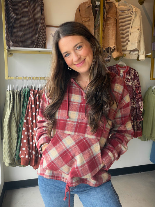 
Cozy meets effortlessly cool in this lightweight flannel plaid pullover hoodie from Doe &amp; Rae. Crafted in a rich red brick plaid, it's the kind of layer you'll reach for again and again — whether you're running errands or lounging on the weekend.

Lightweight flannel construction for all-day comfort
Pullover silhouette with a partial button placket
Attached hood for easy, low-key warmth
Spacious kangaroo pocket to keep your hands cozy
100% Polyester
Style Measurements (Size Small)

Total Length: 24½"
B