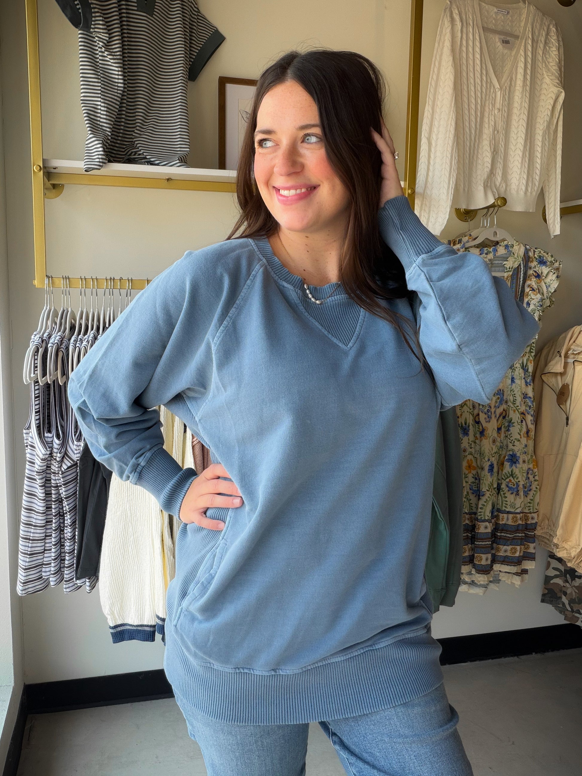 Soft, slouchy, and seriously cozy. The Dusty Blue Pigment Dyed Pullover by Zenana is your new favorite weekend essential. Made from 100% cotton French terry, it has that perfectly worn-in feel with a pigment dye finish that gives it a subtle, vintage-inspired depth of color unique to each piece.

Ribbed detailing adds a polished touch, and the handy pockets make it as practical as it is stylish. Whether you're running errands or lounging at home, this relaxed pullover does it all in effortless dusty blue.
