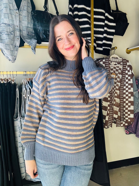 Brand: Lumiere

Crafted with a mock neck and classic striped design, this Dusty Blue Striped Sweater is a timeless piece for your cold weather wardrobe. Made with super soft material, it offers both comfort and style. Perfect for those who want to make a statement while maintaining a feminine and professional look.