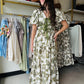 Entro

This Olive Floral Midi Dress combines elegance and comfort with its short bubble sleeves and flattering elasticated waist at the back. Crafted from lightweight woven fabric, it features a delicate floral print and a contrasting bow accent at the front for a refined touch. Fully lined and non-sheer, it offers modest coverage while side pockets add practical convenience. Ideal for stylish, effortless wear throughout the day.