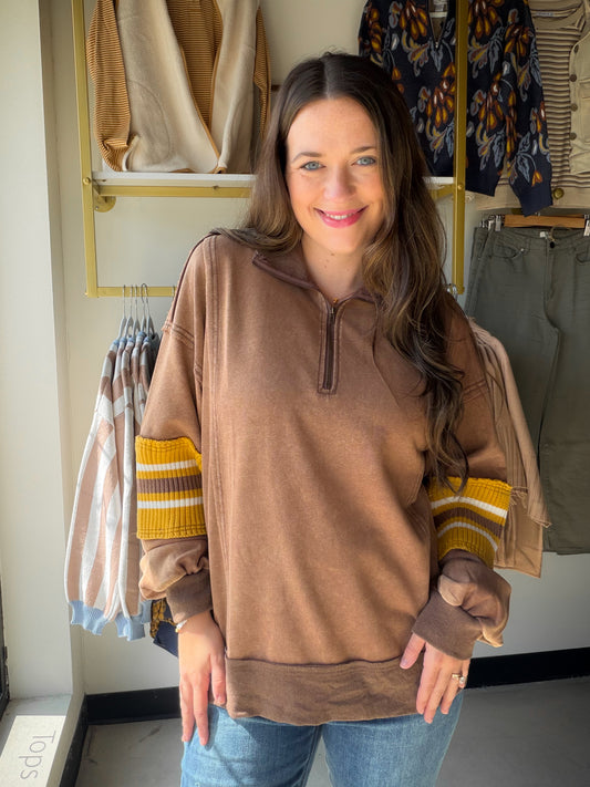 Your new favorite weekend pull. The&nbsp;Mocha Accent Sleeve Half Zip by Easel is a washed terry pullover that hits the sweet spot between cozy and cool — mineral-washed fabric with a soft, lived-in feel, a mock collared neckline, and striped ribbed sleeve panel detail in mocha that makes it feel anything but basic. Relaxed, oversized, and endlessly layerable.

Why You'll Love It

Mineral washed terry fabric — soft, broken-in feel from the first wear
Mocha striped ribbed sleeve panel 