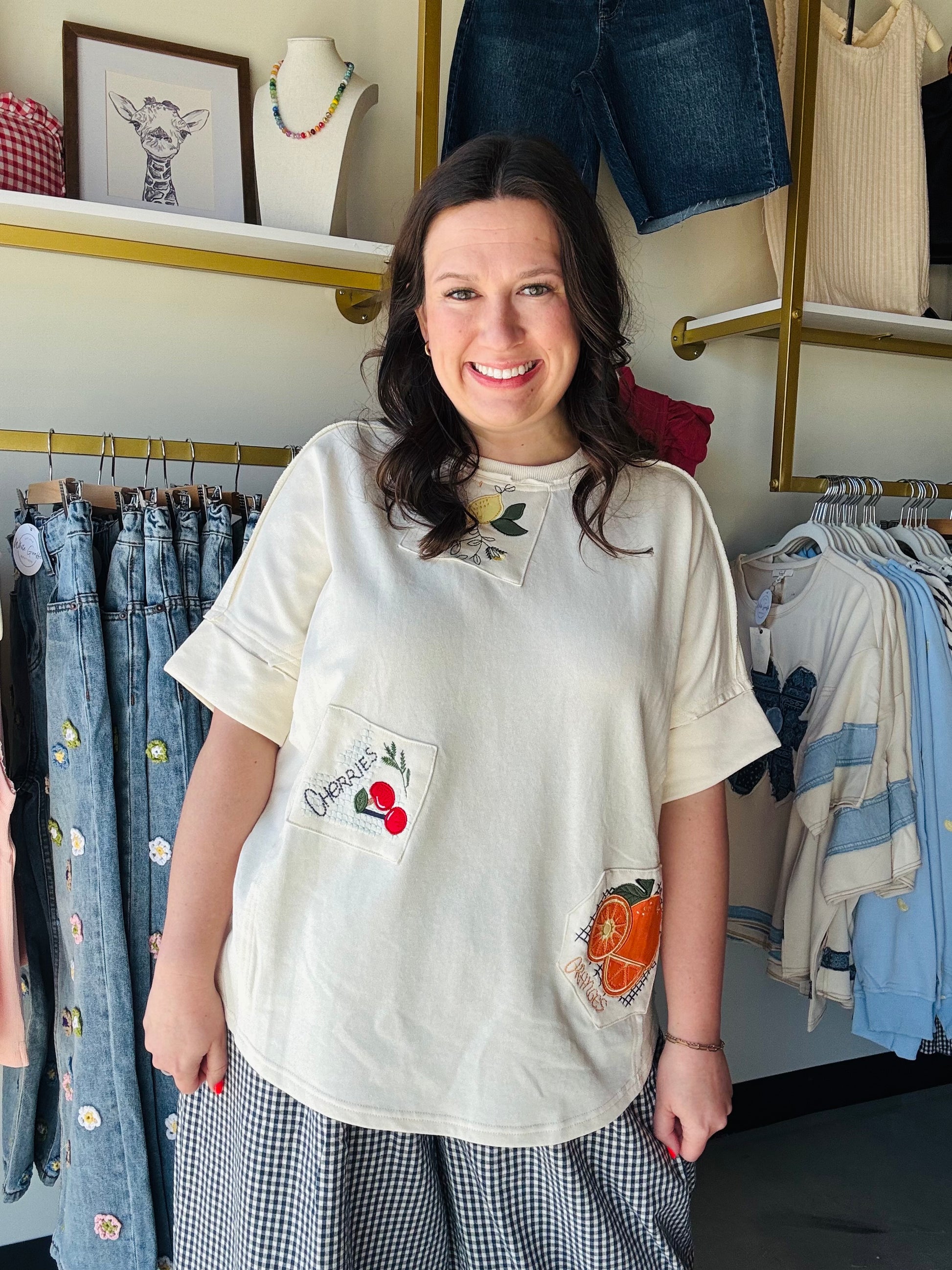 Easel

Brighten your everyday style with this playful, oversized terry knit top featuring charming fruit embroidery patches. Designed with a relaxed silhouette and breathable half-sleeves, it’s the ultimate blend of cozy comfort and whimsical personality.

Breathable terry knit for all-day comfort.
Relaxed, oversized fit flatters every body.
Charming handcrafted fruit patch detailing.
Versatile half-sleeves for effortless layering.
Timeless crew neck for classic styling.
Ultra-soft fabric feels like a dream