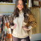 Meet your new go-to layer. The Mustard Sides Floral Accent Hoodie from Easel brings together the lived-in ease of mineral-washed terry with a playful floral print mix — the kind of piece that looks effortless whether you're running errands or catching up over coffee.

A relaxed, slightly oversized silhouette drapes beautifully, while the attached drawstring hood and front kangaroo pocket keep things cozy and functional. The floral chest pocket and contrast print panels add just the right amount of personali