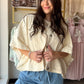 The ultimate throw-on-and-go layer. The Ecru Denim Poncho Jacket by Wishlist combines the ease of a poncho with the structure of a denim jacket for a one-of-a-kind outerwear piece that works with virtually everything in your wardrobe. Crafted from 100% cotton denim in a clean ecru tone, it features functional buttons and side detail for a polished, intentional finish. With its generous, relaxed silhouette, this is the kind of jacket that looks effortlessly cool whether you're layering over a sundress or you