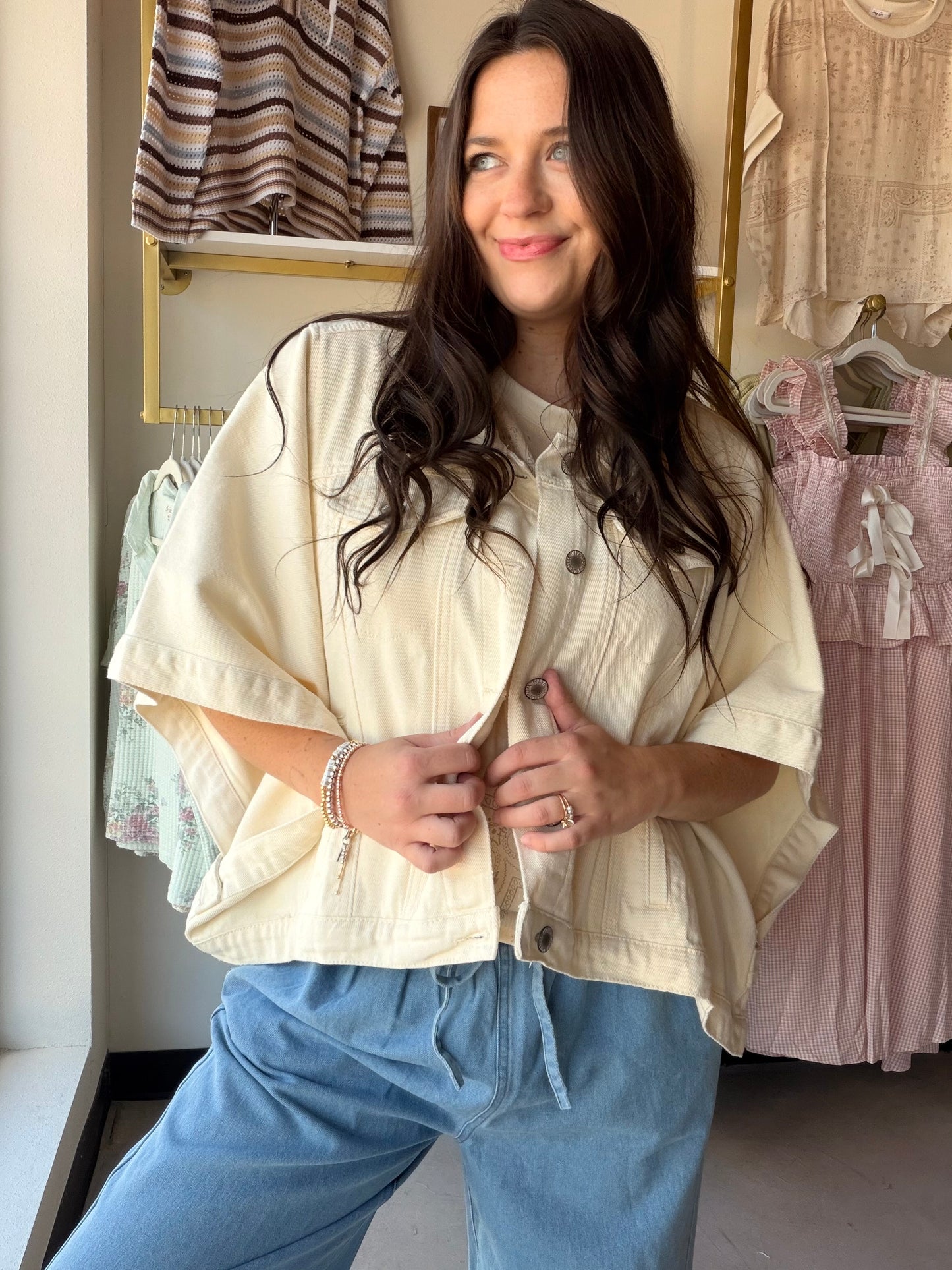 The ultimate throw-on-and-go layer. The Ecru Denim Poncho Jacket by Wishlist combines the ease of a poncho with the structure of a denim jacket for a one-of-a-kind outerwear piece that works with virtually everything in your wardrobe. Crafted from 100% cotton denim in a clean ecru tone, it features functional buttons and side detail for a polished, intentional finish. With its generous, relaxed silhouette, this is the kind of jacket that looks effortlessly cool whether you're layering over a sundress or you