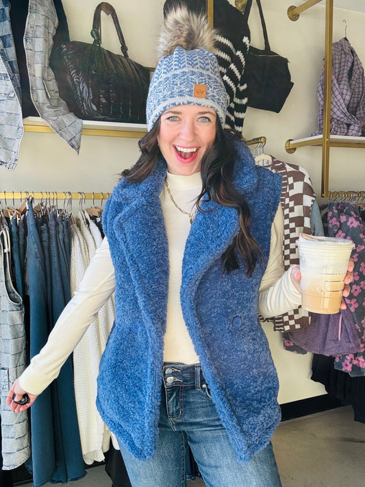 This Electric Blue Oversized Vest will keep you warm and stylish. Its fuzzy texture and oversized design add a playful touch to any outfit. The notched collared neckline and button front provide versatility, and the pockets are perfect for storing essentials. Stay cozy and fashionable with this sleeveless vest.